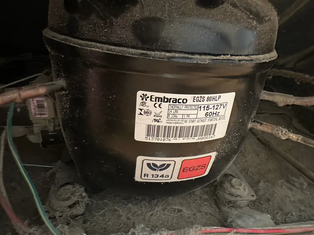 Compressor of a Whirlpool refrigerator during a start relay replacement
