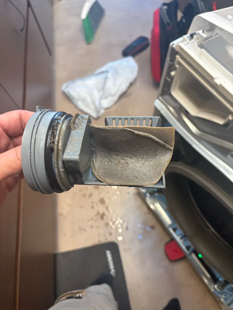 Lint and debris in the drain pump filter of a Whirlpool front-load washer