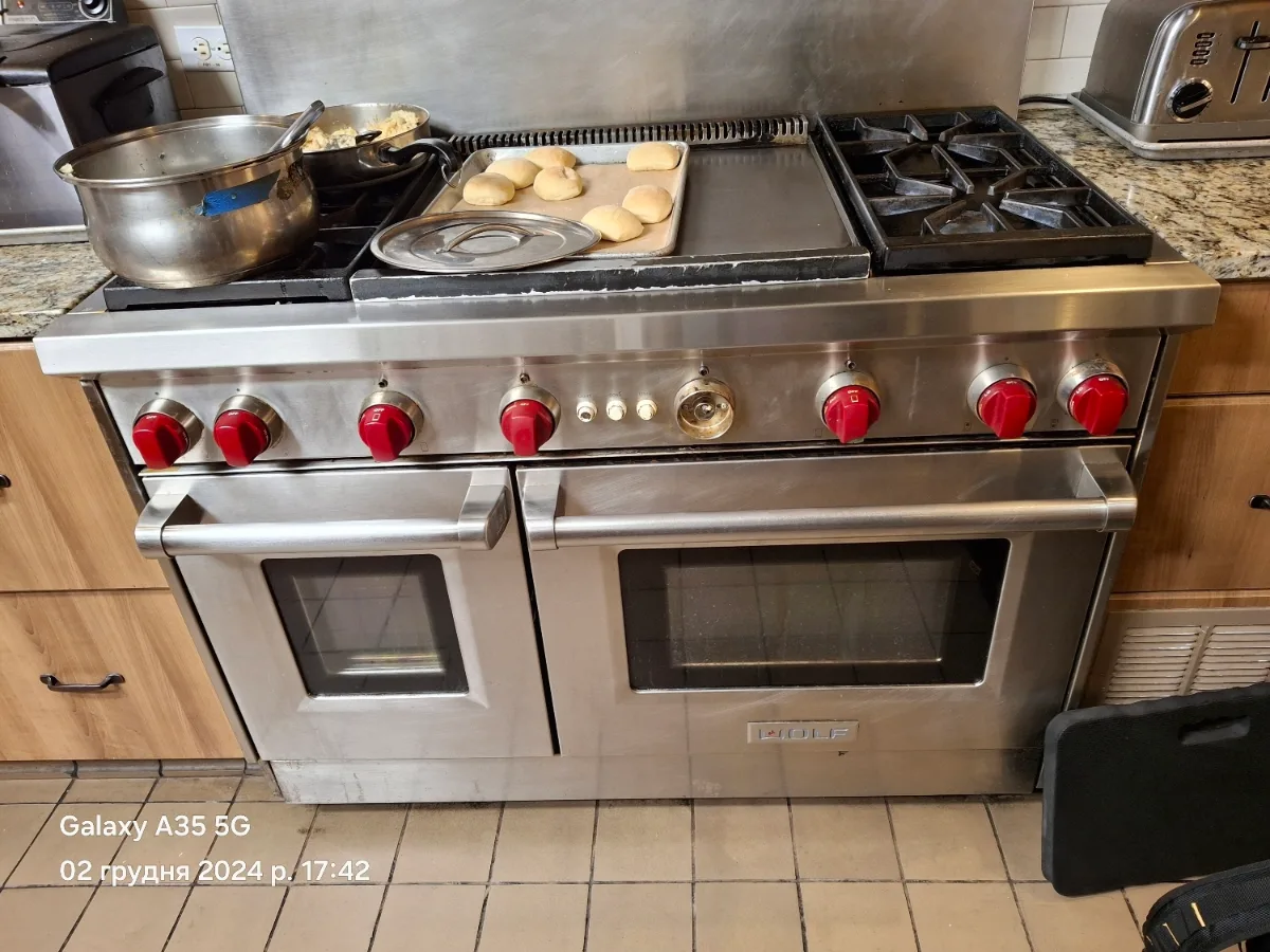 Wolf 48-inch dual-fuel range with a griddle and red knobs